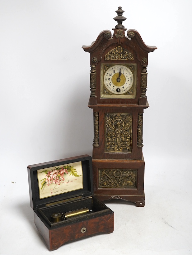 A miniature longcase clock and a miniature yew cylinder musical box, largest 42cm high. Condition - box poor, clock good